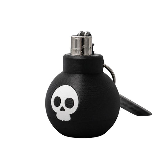 Briquet Boum Superstuff noir en forme de bombe avec tête de mort blanche